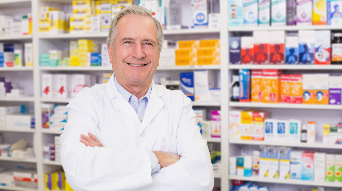 Older Male Pharmacist in Front of Medications