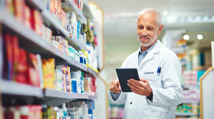 Older Pharmacist Checking Inventory