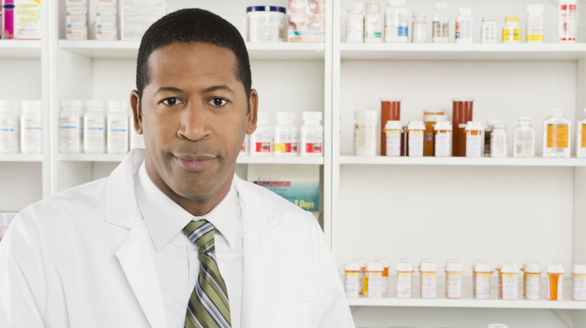 Pharmacist in front of prescriptions